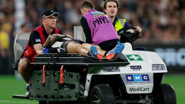 Jeremy Howe of the Magpies leaves the field on a stretcher during the 2023 AFL Round 01 match between the Geelong Cats and the Collingwood Magpies at the Melbourne Cricket Ground.