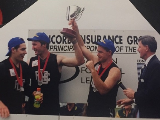 Derek Coghlan and Alan Richardson show off the 1999 premiership spoils. Picture: Supplied