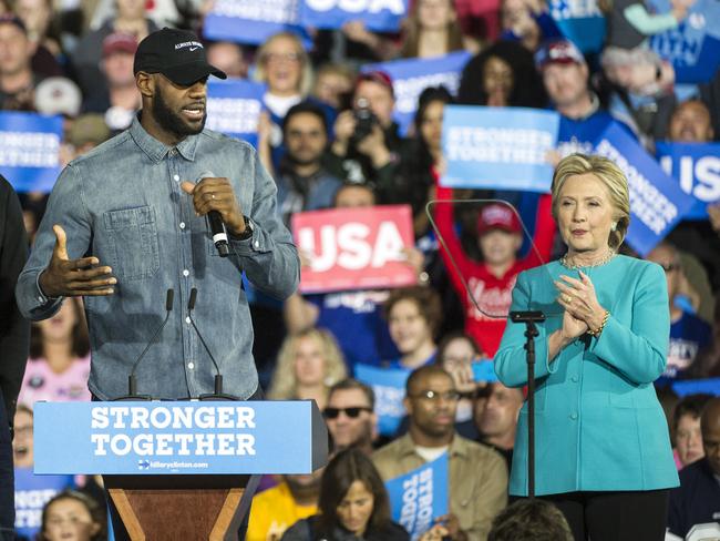 Cleveland Cavaliers star LeBron James speaks as Democratic presidential candidate Hillary Clinton claps during a campaign rally at Cleveland Public Hall in Cleveland, Sunday, Nov. 6, 2016. (AP Photo/Phil Long)