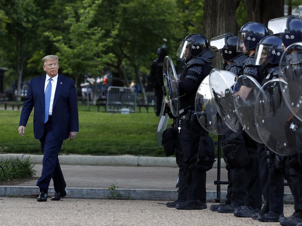 The President walks past police in Lafayette Park after visiting the church. Picture: Patrick Semansky/AP