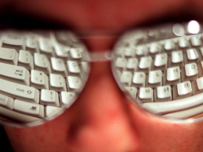 Person wearing sunglasses showing reflection of computer keyboard 08 Jun 2000. spectacles eyewear reflections