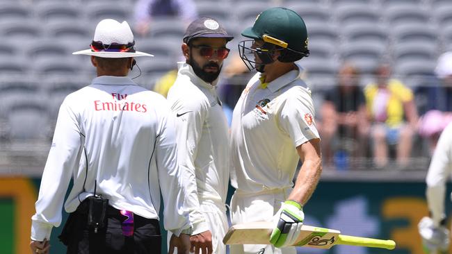 Virat Kohli sticks his imposing and powerful chest into the weak, pitiful excuse for a torso of Australian captain Tim Paine. Picture: AAP