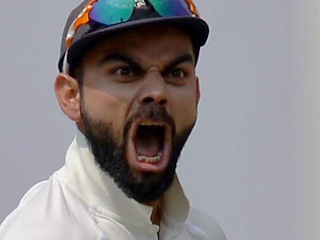 Indian cricket captain Virat Kohli celebrates the dismissal of Australian batsman Matthew Wade during the fourth day of the second Test match between India and Australia at The M. Chinnaswamy Stadium in Bangalore on March 7, 2017. / AFP PHOTO / Manjunath KIRAN / ----IMAGE RESTRICTED TO EDITORIAL USE - STRICTLY NO COMMERCIAL USE----- / GETTYOUT