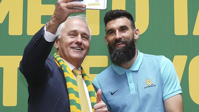 Australian Prime Minister Malcolm Turnbull takes a selfie with Socceroos captain Mile Jedinak. Picture: AP