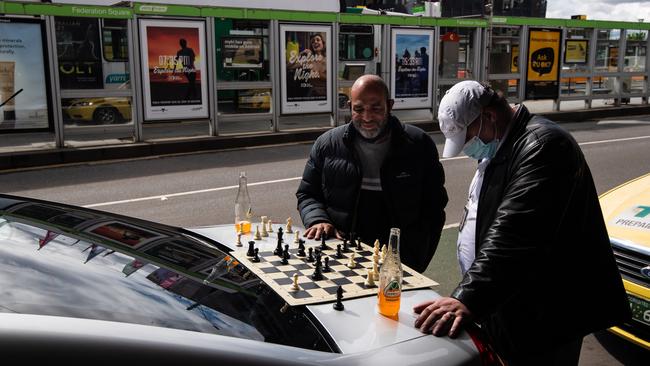 Bored Melbourne taxi drivers kill time with a game of chess. Picture: Jason Edwards