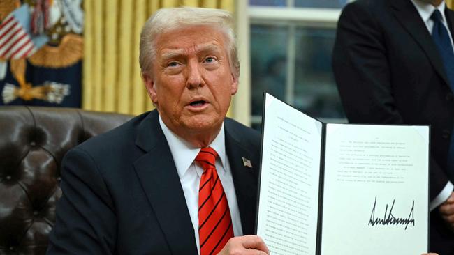 US President Donald Trump signs an executive order in the Oval Office imposing 25 per tariffs on steel and aluminium imports. Picture: AFP