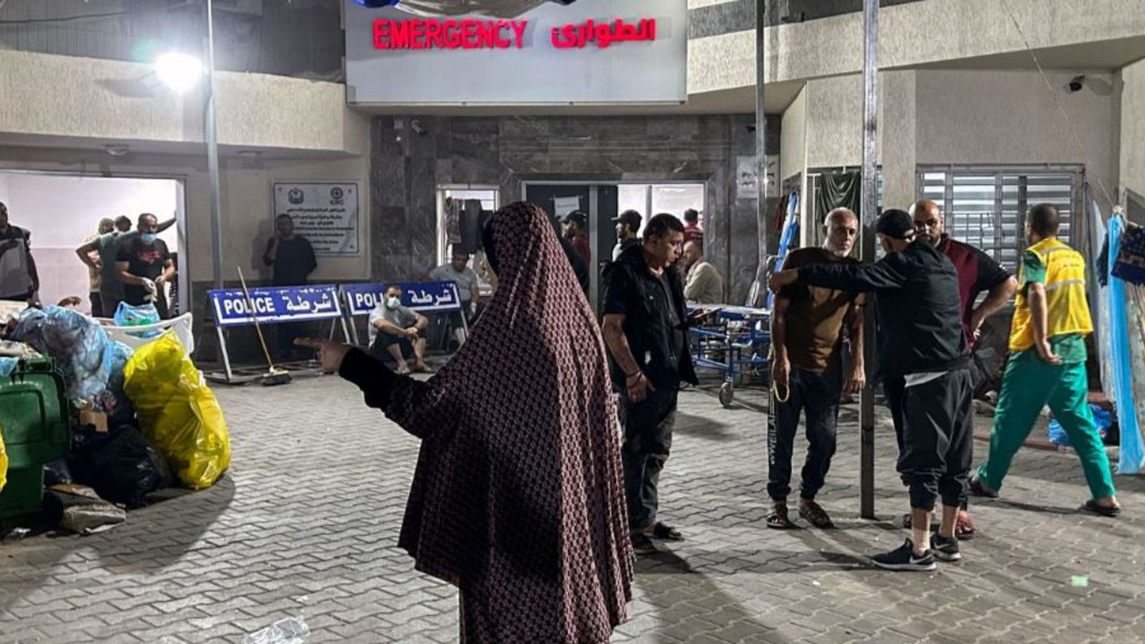 People stand outside the emergency ward of Al-Shifa hospital in Gaza city. Picture: Khader Al Zanoun / AFP / Getty Images