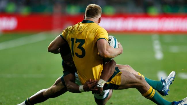 Australia's utility back Reece Hodge (13) is rocked by the South African defence. Picture: AFP