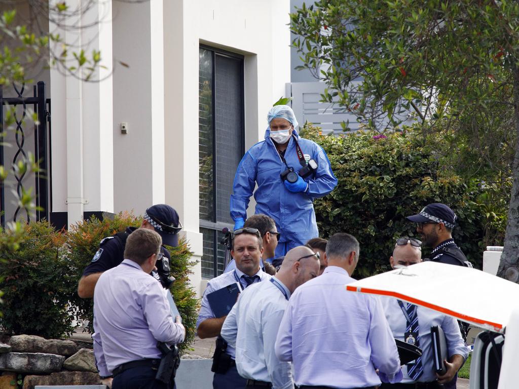 Police and detectives outside the house in Varsity Lakes where the body of a 82 year old female was found. Picture: Tertius Pickard