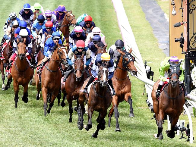 The field heads out of the straight on the first occasion. Picture: Nicole Garmston