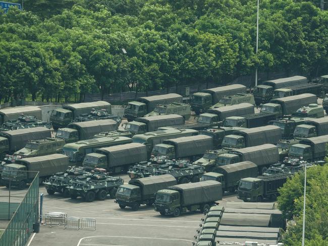 Trucks and armoured personnel carriers are seen outside the Shenzhen Bay stadium in Shenzhen, bordering Hong Kong. Picture: AFP