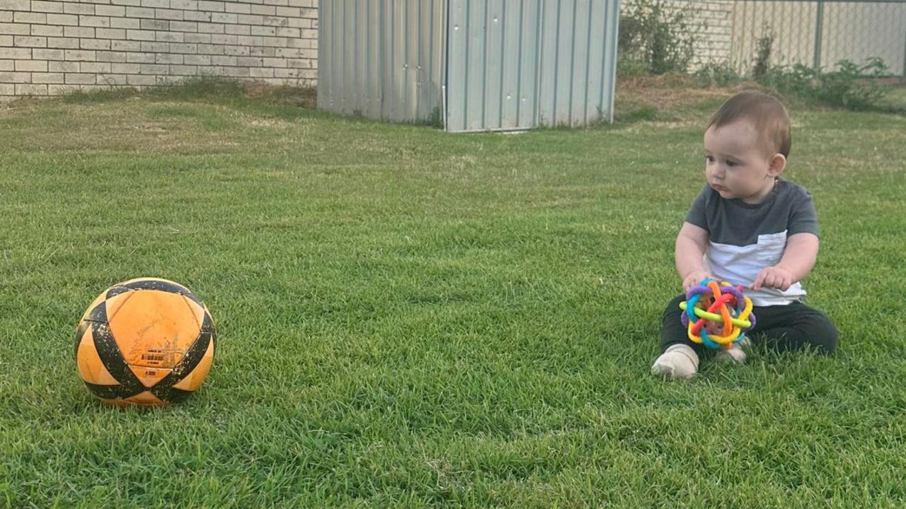 Cooper enjoys watching his dad play sport in their backyard.