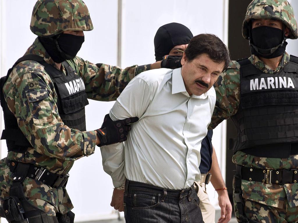 In this file photo taken on February 22, 2014 Mexican drug trafficker Joaquin Guzman Loera aka "El Chapo Guzman" (C), is escorted by marines as he is presented to the press in Mexico City. Picture: AFP