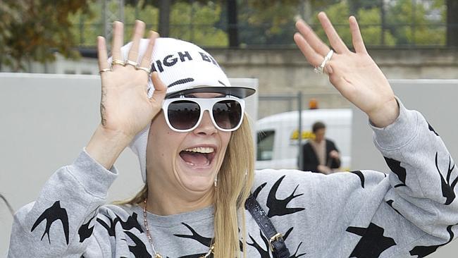Cara Delevingne absolutely loves her fans ... and flat caps ... and beanies. Picture: Splash