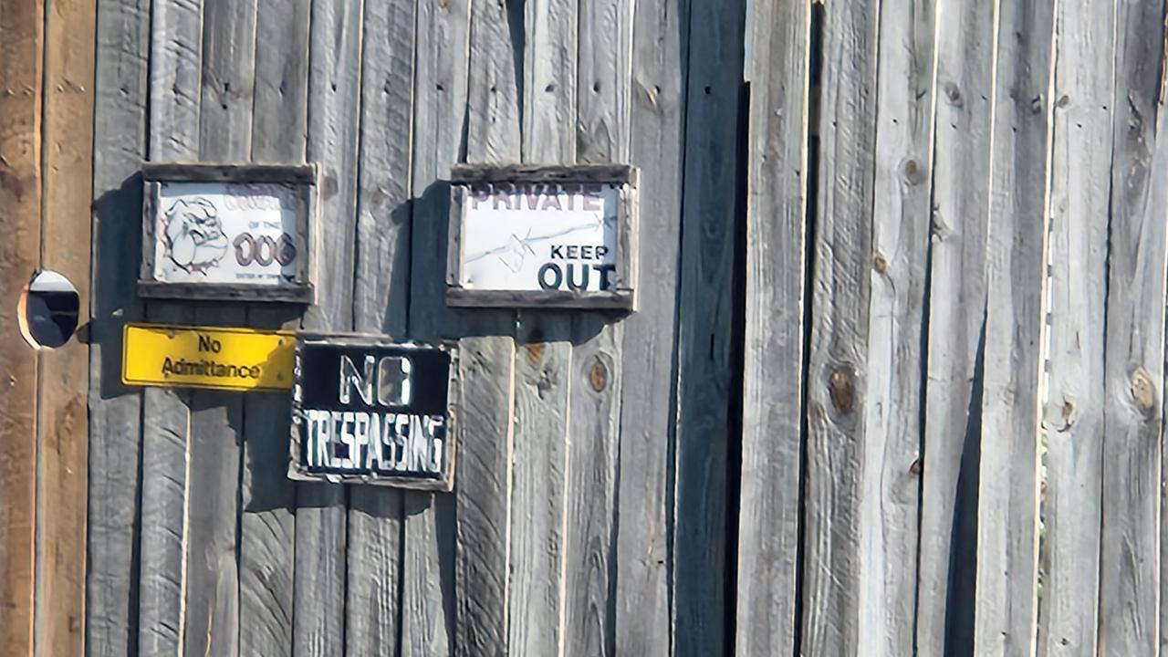 Signs on the front gate at the Bank Street house, Park Avenue, North Rockhampton, on Sunday, September 11, 2022.