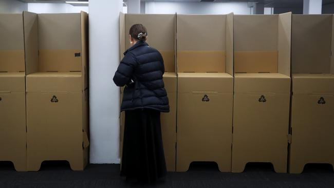 A person votes at an early polling centre in the central business district in Sydney.