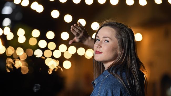 DAZZLING: Florence Holland shields her eyes from the bright “ambience” lights in Peel St. Picture: Tom Huntley