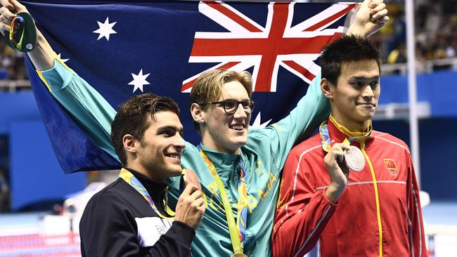 Mack Horton holds the Australian flag.