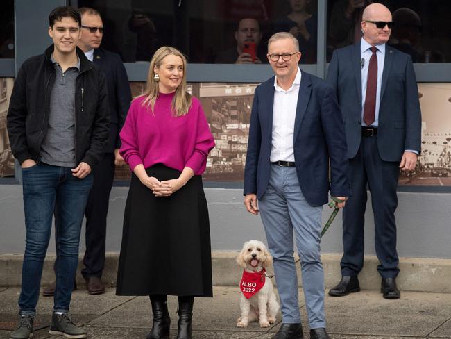 Nathan Albanese, with Jodie Haydon and new PM Anthony Albanese, heading to vote on Saturday, with their cavoodle Toto. Picture: Wendell Teodoro / AFP