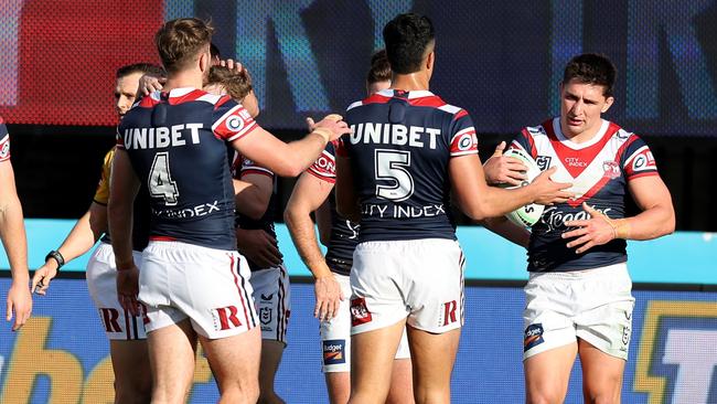 Victor Radley, right, celebrates with teammates after scoring the Roosters’ opening try against the Dragons. Picture: Scott Gardiner/Getty Images