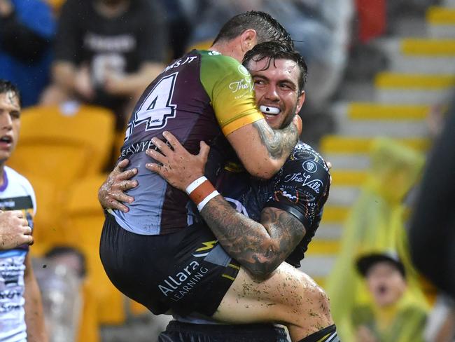 Kyle Feldt celebrates scoring a try with Ben Hampton.