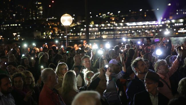 Protesters shine torches up on the Opera House sails in an attempt to disrupt the light display for The Everest barrier draw. Picture: Christian Gilles