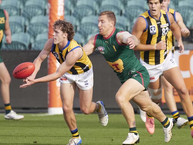 Tasmania's Brad Cox-Goodyer looks to lay a tackle in Sunday’s win over Sandringham. Picture: Rod Thompson