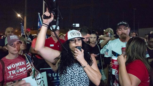 A woman yells her anger in a microphone as Trump supporters gather in front of the Maricopa County Election Department where ballots are counted after the US presidential election in Phoenix, Arizona. Picutre: AFP