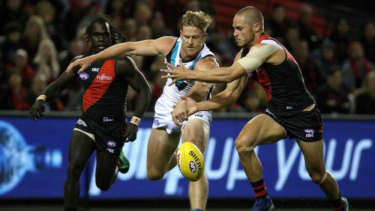 Tom Jonas of the Power (left) contests with David Zaharakis of the Bombers during the Round 4 AFL match between the Essendon Bombers and the Port Adelaide Power at Etihad Stadium in Melbourne, Sunday, April 15, 2018. (AAP Image/Hamish Blair) NO ARCHIVING, EDITORIAL USE ONLY