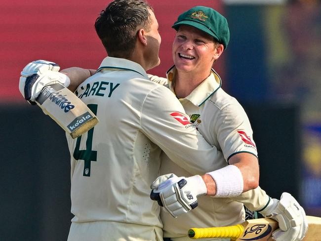 Australia's Alex Carey (L) celebrates with his captain Steve Smith after scoring a century (100 runs) during the second day of the second Test cricket match between Sri Lanka and Australia at the Galle International Cricket Stadium in Galle on February 7, 2025. (Photo by Ishara S. KODIKARA / AFP)