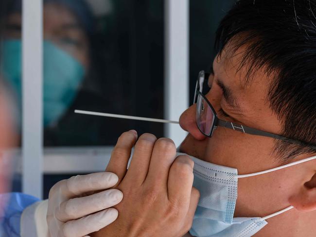 A man is tested for the virus in Wuhan. Picture: AFP