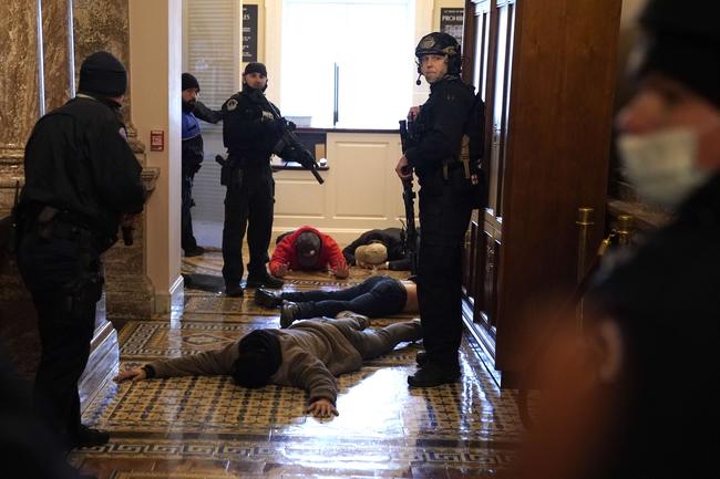 WASHINGTON: U.S. Capitol Police detain protesters outside of the House Chamber during a joint session of Congress. Picture: Drew Angerer/Getty Images/AFP