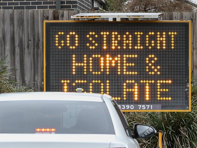 MELBOURNE, AUSTRALIA - JULY 04: A sign reading 'Go straight home and Isolate' is seen at the exit of a drive through covid-19 testing site at Highpoint shopping centre on July 04, 2020 in Melbourne, Australia. Lockdowns across Melbourne are in effect for residents of suburbs identified as COVID-19 hotspots following a spike in new coronavirus cases through community transmission. Residents of the 10 Melbourne hotspot postcodes are only able to leave home have for exercise or work, to buy essential items including food or to access childcare and healthcare. Businesses and facilities in these lockdown areas are also restricted and cafes and restaurants can only open for takeaway and delivery. The restrictions will remain in place until at least 29 July.  (Photo by Asanka Ratnayake/Getty Images)