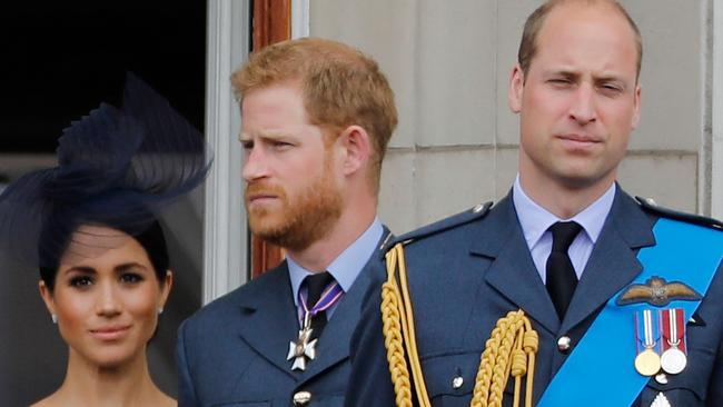 Meghan, Harry and William on the balcony of Buckingham Palace when the rift between the brothers was already beginning to show. Picture: AFP.