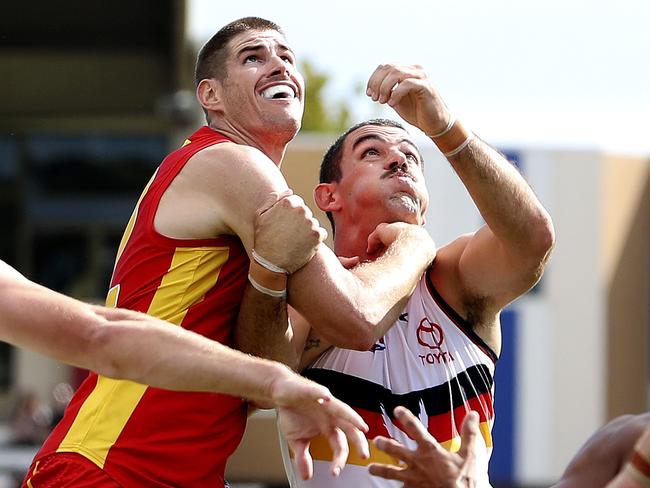 AFL - Adelaide Crows v Gold Coast at Noarlunga Oval. Taylor Walker contests the boundary throw in with Zac Smith Picture SARAH REED
