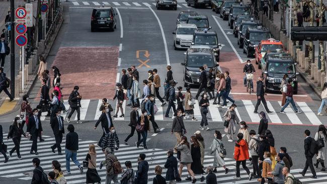 TOKYO, JAPAN - APRIL 03: People, some wearing face masks, cross a road in Shibuya on April 03, 2020 in Tokyo, Japan. Although Japan has so far been spared the explosive surge of Covid-19 coronavirus infections seen in some European countries, Prime Minister Shinzo Abe is coming under increased pressure to take tougher measures to tackle the rising infection rate in the country. Tokyo continues to have the highest number of infections of any prefecture with 684 cases although it remains a comparatively small figure compared to the citys 14 million population. (Photo by Carl Court/Getty Images)