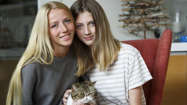 Ash Adcock, Pink Floyd (cat) and Paris Adcock in their Newport home. Picture: AAP IMAGE/ Tim Pascoe