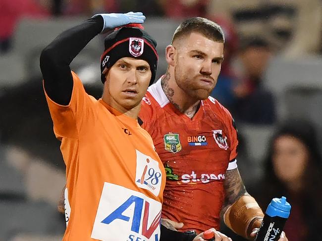 Josh Dugan of the Dragons (right) is taken off the pitch during the NRL Round 19 match between the Canberra Raiders and St.George Illawarra Dragons at the GIO Stadium in Canberra on Friday, July 14, 2017. (AAP Image/David Moir) NO ARCHIVING, EDITORIAL USE ONLY