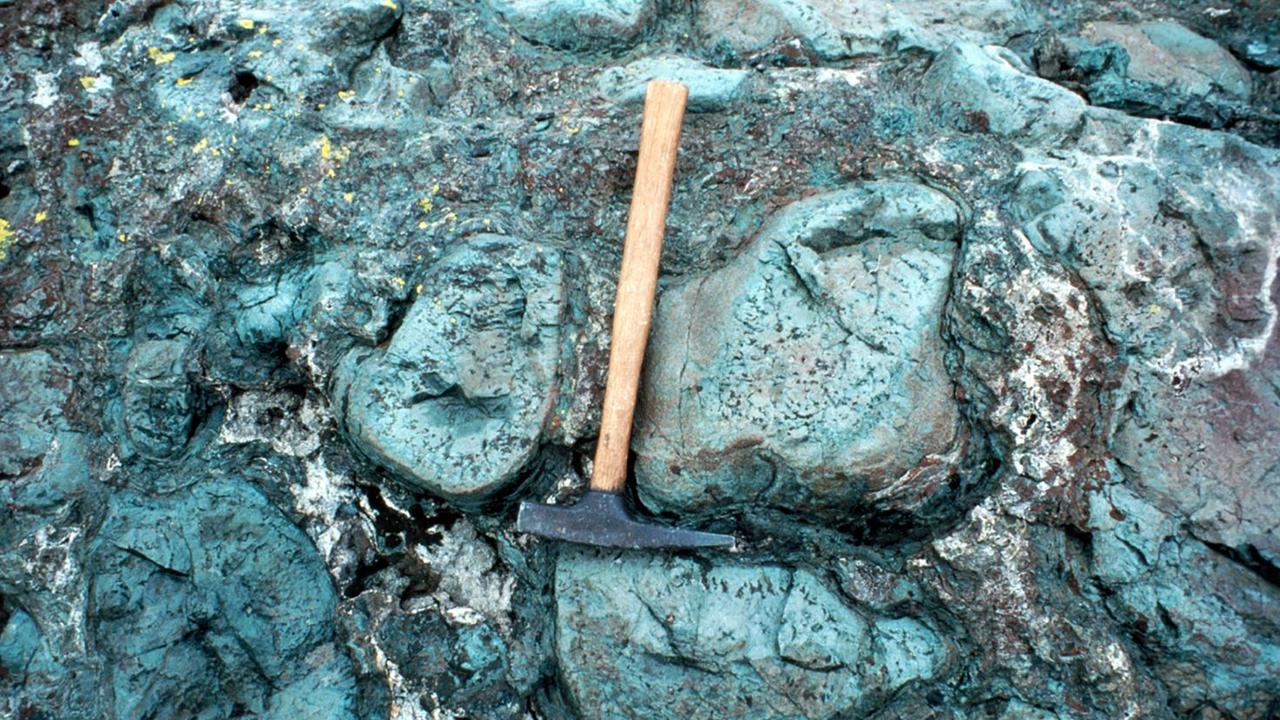 Hyaloclastite, seen here ribboned between the margins of lava rock, is an accumulation of sea glass formed during volcanic eruptions underwater or ice. Picture: USGS