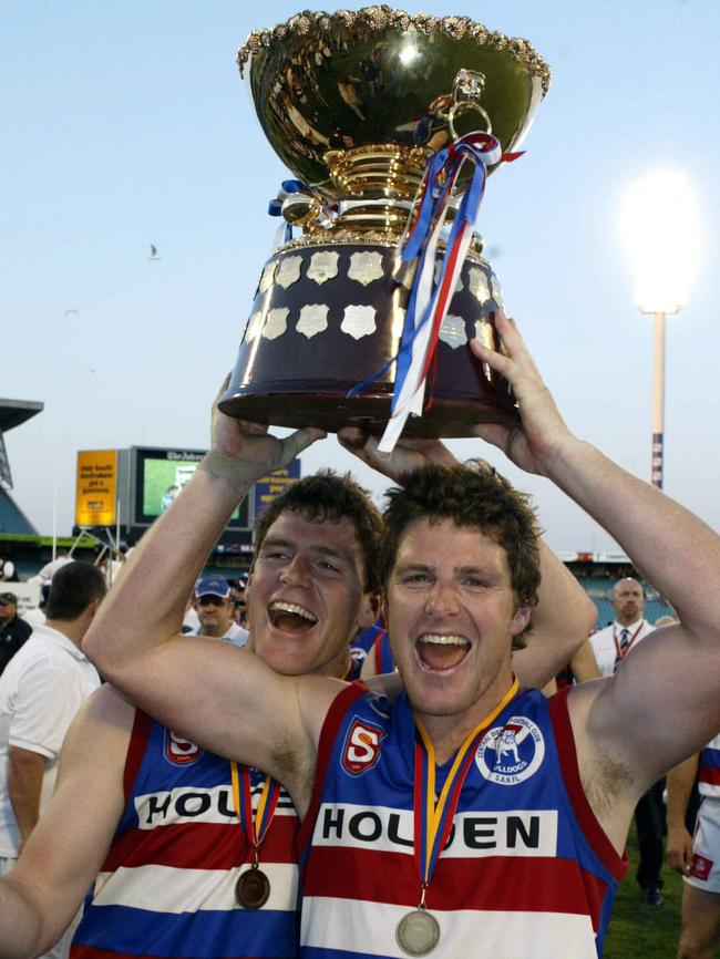 Central District’s Chris and James Gowans hold the SANFL Premiership trophy in 2005.