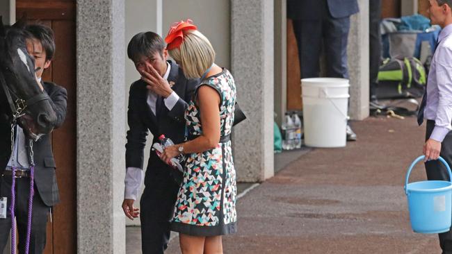 Skikato Kayoshi, strapper of Admire Rakti, is reduced to tears after the horse broke down and died shortly after the 2014 Melbourne Cup.