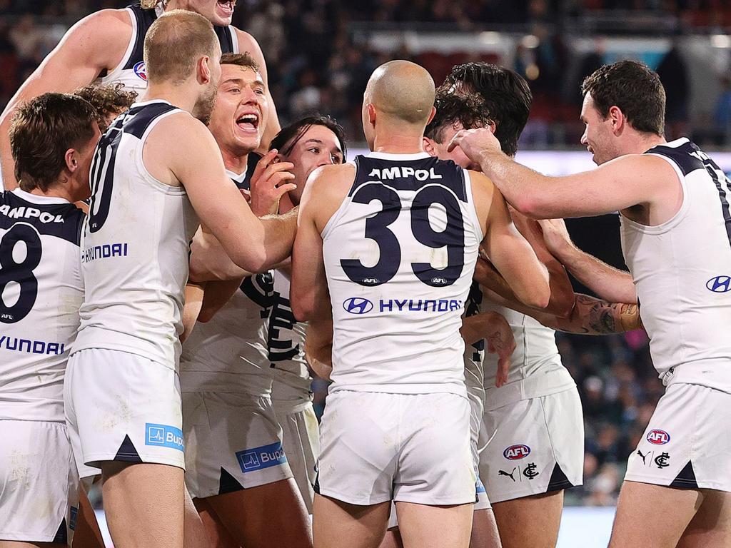 ADELAIDE, AUSTRALIA - MAY 30: Carlton players mob Zac Williams after his goal during the 2024 AFL Round 12 match between the Port Adelaide Power and the Carlton Blues at Adelaide Oval on May 30, 2024 in Adelaide, Australia. (Photo by Sarah Reed/AFL Photos via Getty Images)