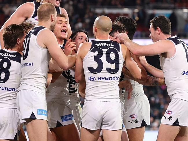 ADELAIDE, AUSTRALIA - MAY 30: Carlton players mob Zac Williams after his goal during the 2024 AFL Round 12 match between the Port Adelaide Power and the Carlton Blues at Adelaide Oval on May 30, 2024 in Adelaide, Australia. (Photo by Sarah Reed/AFL Photos via Getty Images)