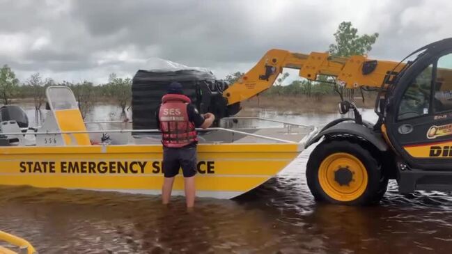 Ashley Gallagher helping Troy Gallagher, Troy Bentvelzen and Bradley Hawkins load floodboats on the Croyden side of the Norman River in the Gulf to deliver goods to towns cut-off by flooding