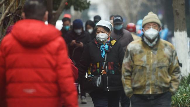 Residents walk along a street in Hangzhou, in China's eastern Zhejiang province. Picture: AFP