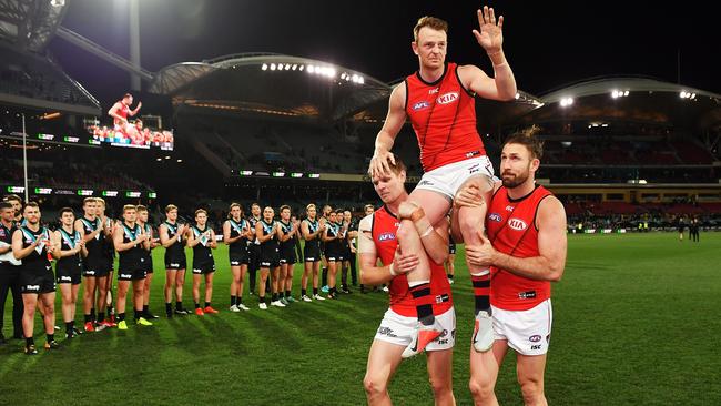 Brendon Goddard is chaired off by Michael Hurley and Cale Hooker.