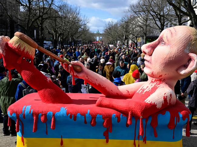 – An effigy of Russian President Vladimir Putin bathing in a bath of blood is seen at a rally in front of the Russian embassy in Berlin, where voters lined. Picture: AFP