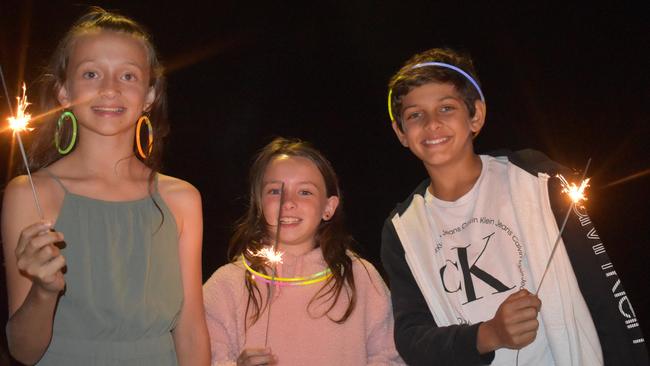 Zahli, Kaleb and Maya (no surnames given) celebrating New Year's Eve 2022 at Mooloolaba. Photo: Elizabeth Neil