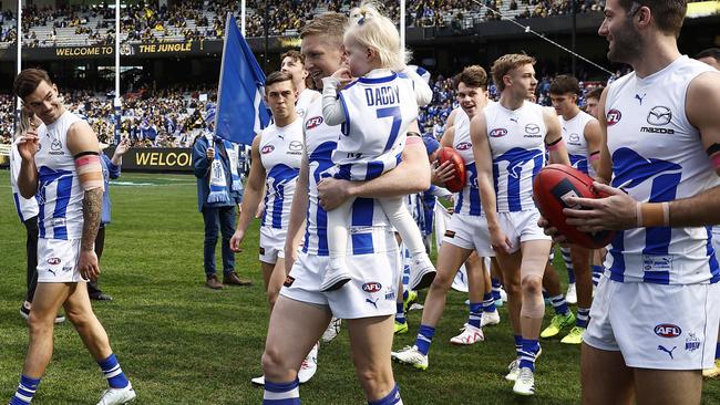 MELBOURNE, AUSTRALIA – AUGUST 19: Jack Ziebell of the Kangaroos runs out with his daughter during the round 23 AFL match between Richmond Tigers and North Melbourne Kangaroos at Melbourne Cricket Ground, on August 19, 2023, in Melbourne, Australia. (Photo by Daniel Pockett/Getty Images)