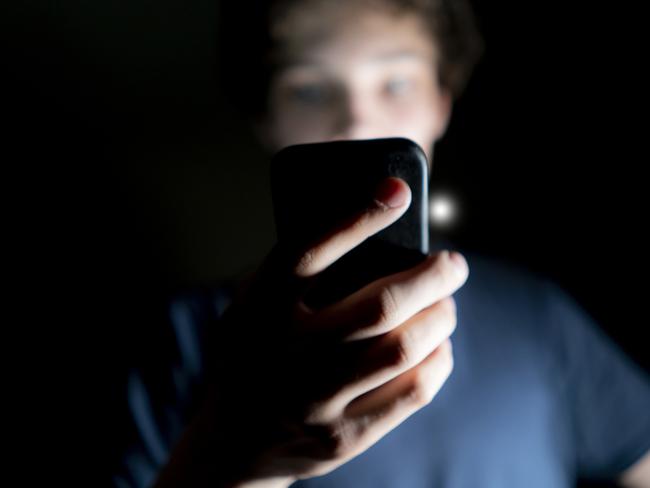 young attractive man use mobile phone late at night in a dark room Picture: Istock